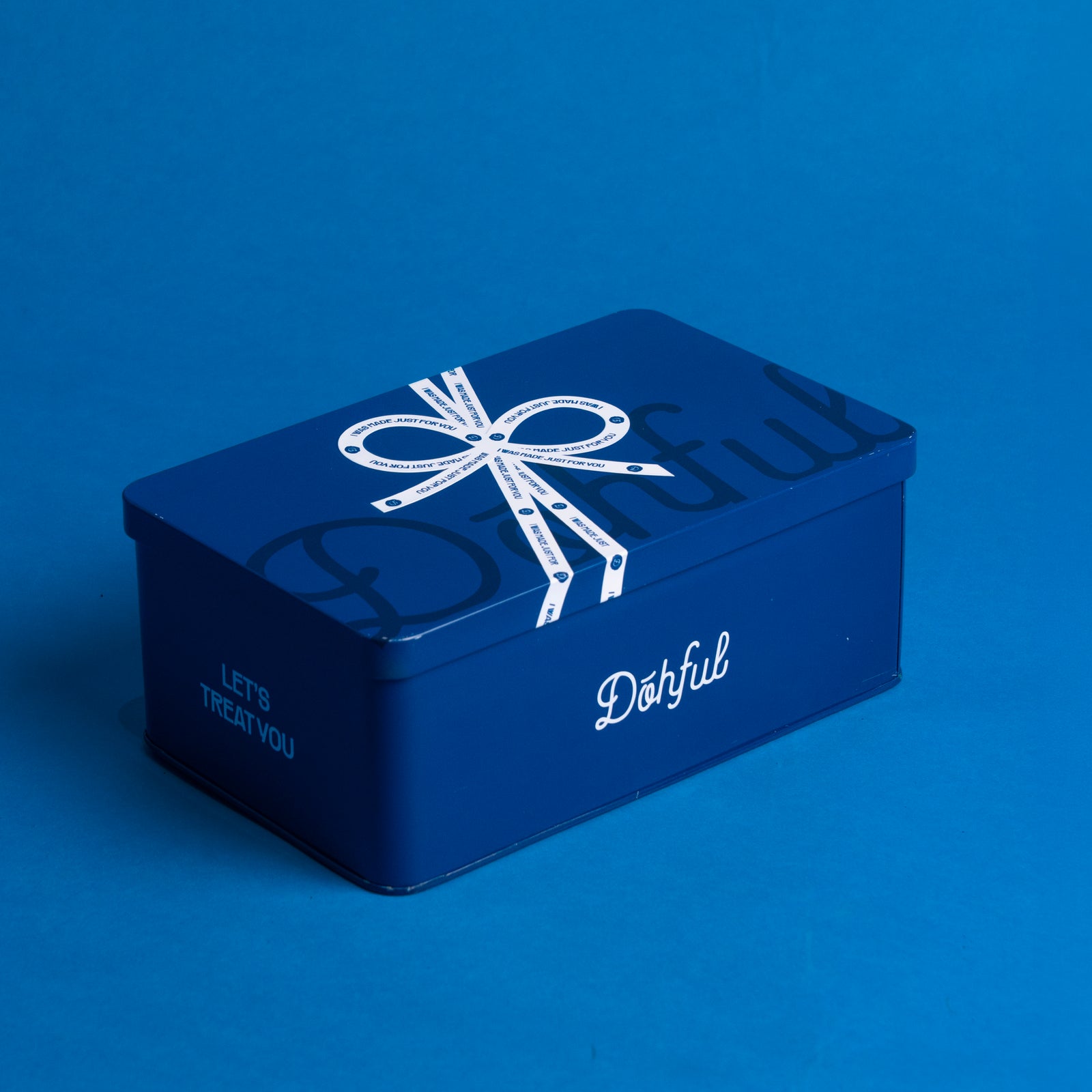 Dohful branded blue cookie tin with a ribbon